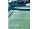 Well-maintained outdoor tennis court with a green surface, net, and surrounding trees at 2700 Bayshore Blvd # 2308, Dunedin, FL 34698
