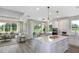 Open floor plan with views of living, dining, and kitchen areas featuring an island and stainless appliances at 36812 Rio Grande Dr, Zephyrhills, FL 33540