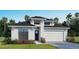 New construction home featuring a modern elevation, two-car garage, and manicured landscaping at 3719 109Th Street East, Palmetto, FL 34221