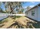 Spacious backyard featuring a privacy fence and mature tree with Spanish moss, ideal for relaxation and recreation at 3904 Executive Cir, Plant City, FL 33566