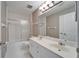 Well-lit bathroom features a double sink vanity, tile floors, and a shower-tub combination with modern fixtures at 3904 Executive Cir, Plant City, FL 33566