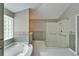 Bathroom featuring glass shower, soaking tub, vanity sinks, and neutral paint at 3904 Executive Cir, Plant City, FL 33566