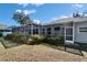 Back of house with a screened lanai, manicured shrubs and a large grassy area, great for outdoor living at 3904 Executive Cir, Plant City, FL 33566