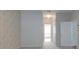 Hallway leading to a bathroom with a shower and tub, with neutral paint at 3904 Executive Cir, Plant City, FL 33566