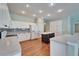 A kitchen with white cabinets, granite counters, a central island, and wood floors at 3904 Executive Cir, Plant City, FL 33566