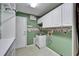 Laundry room features built in cabinets, sink, and shelving at 3904 Executive Cir, Plant City, FL 33566