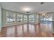 Open-concept living area with hardwood floors, ceiling fans, and large windows at 3904 Executive Cir, Plant City, FL 33566