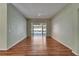 Open living area with hardwood floors and a view of the outdoor pool at 3904 Executive Cir, Plant City, FL 33566