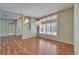 Spacious living room with hardwood floors, large windows, and a chandelier at 3904 Executive Cir, Plant City, FL 33566