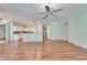 Spacious living area with wood floors adjacent to a modern, open kitchen at 3904 Executive Cir, Plant City, FL 33566