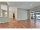 Living room with hardwood floors and a view of the pool through sliding glass doors at 3904 Executive Cir, Plant City, FL 33566