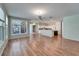 Bright, open living area with hardwood floors, kitchen access, and ample natural light at 3904 Executive Cir, Plant City, FL 33566