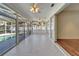 Large enclosed tile patio with ceiling fans and views of a pool and backyard at 3904 Executive Cir, Plant City, FL 33566