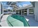 Screened-in pool with clean blue water, patio area, and a view of the house at 3904 Executive Cir, Plant City, FL 33566