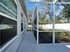 View of the home's screened porch leading to the backyard with privacy fence, perfect for outdoor enjoyment at 3904 Executive Cir, Plant City, FL 33566