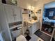 Bathroom featuring white cabinetry, beach-themed decor, and access to the bedroom at 3934 37Th S St # 36, St Petersburg, FL 33711