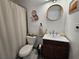 Bathroom with custom wood vanity, round mirror, and beachy decor at 3934 37Th S St # 36, St Petersburg, FL 33711