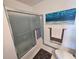 Bathroom showcasing a shower with a sliding glass door and ocean-themed artwork at 3934 37Th S St # 36, St Petersburg, FL 33711