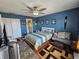 Comfortable bedroom with blue walls, a ceiling fan, and ensuite bathroom access at 3934 37Th S St # 36, St Petersburg, FL 33711