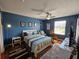 Bedroom with a ceiling fan, bright blue walls, and ample natural light at 3934 37Th S St # 36, St Petersburg, FL 33711