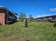 Exterior of apartment complex with green grass and mature trees at 3934 37Th S St # 36, St Petersburg, FL 33711