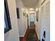 Hallway leading to the front door with hardwood floors and decorative accents at 3934 37Th S St # 36, St Petersburg, FL 33711