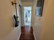 Hallway with hardwood floors and a guitar hanging on the wall at 3934 37Th S St # 36, St Petersburg, FL 33711