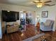 An open-concept living room with hardwood floors, ceiling fan, and natural lighting at 3934 37Th S St # 36, St Petersburg, FL 33711