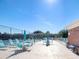 Community tennis court with tables, chairs, umbrellas, and lounge seating at 3934 37Th S St # 36, St Petersburg, FL 33711