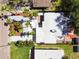 Aerial view of the property features the house and yard with palms trees and concrete driveway at 3934 Huntington Ne St, St Petersburg, FL 33703
