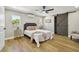 Stylishly furnished bedroom with hardwood floors, ceiling fan, and sliding barn door at 3934 Huntington Ne St, St Petersburg, FL 33703