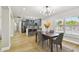 Dining room open to the remodeled kitchen, hardwood floors, natural light, and modern finishes at 3934 Huntington Ne St, St Petersburg, FL 33703