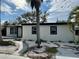 Side view of this single Gathering home, showcasing black trim around windows, minimalist landscaping, and a contemporary design at 3934 Huntington Ne St, St Petersburg, FL 33703