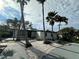 Charming single story home featuring a xeriscape front yard with mature palm trees and a concrete driveway at 3934 Huntington Ne St, St Petersburg, FL 33703