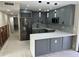 Remodeled kitchen showcasing gray cabinetry, stainless steel appliances, quartz countertops, and stylish light fixtures at 3934 Huntington Ne St, St Petersburg, FL 33703