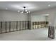 Unfinished living room showcasing bare walls, a modern light fixture, and an open floorplan concept at 3934 Huntington Ne St, St Petersburg, FL 33703