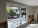 View of the backyard from the sliding glass door with a covered wooden patio at 3934 Huntington Ne St, St Petersburg, FL 33703