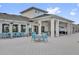 View of outdoor seating at the clubhouse and tables with bright blue chairs at 4023 Wild Senna Blvd, Tampa, FL 33619