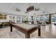 Bright game room showcasing a pool table, ample seating, and abundant natural light at 4023 Wild Senna Blvd, Tampa, FL 33619