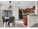 The kitchen features brown cabinets, black appliances and a dining room table next to the island at 4023 Wild Senna Blvd, Tampa, FL 33619
