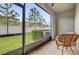 Covered patio with a view of the green backyard and a white fence at 4023 Wild Senna Blvd, Tampa, FL 33619