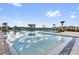 Spacious community pool area with palm trees and plenty of lounge chairs at 4023 Wild Senna Blvd, Tampa, FL 33619