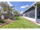 Well maintained backyard with lush green grass, landscaping, and white fence at 4313 Brooke Dr, Valrico, FL 33594