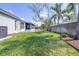 Expansive backyard featuring lush green lawn and mature trees providing shade and privacy at 4313 Brooke Dr, Valrico, FL 33594