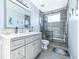 Bathroom featuring a grey vanity, tiled shower, and neutral color palette at 4313 Brooke Dr, Valrico, FL 33594