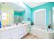 Bright bathroom features a double sink vanity, garden tub, and separate shower at 4313 Brooke Dr, Valrico, FL 33594