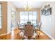 Bright breakfast nook featuring a modern chandelier, stylish table and chairs, and hardwood floors at 4313 Brooke Dr, Valrico, FL 33594