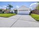Exterior view showcasing a spacious driveway leading to a two-car garage with a manicured lawn at 4313 Brooke Dr, Valrico, FL 33594