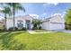 Well-maintained single-story home featuring lush green lawn, tropical landscaping, and a two-car garage at 4313 Brooke Dr, Valrico, FL 33594