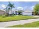 Charming single-story home with a well-manicured lawn, complemented by mature palm trees at 4313 Brooke Dr, Valrico, FL 33594